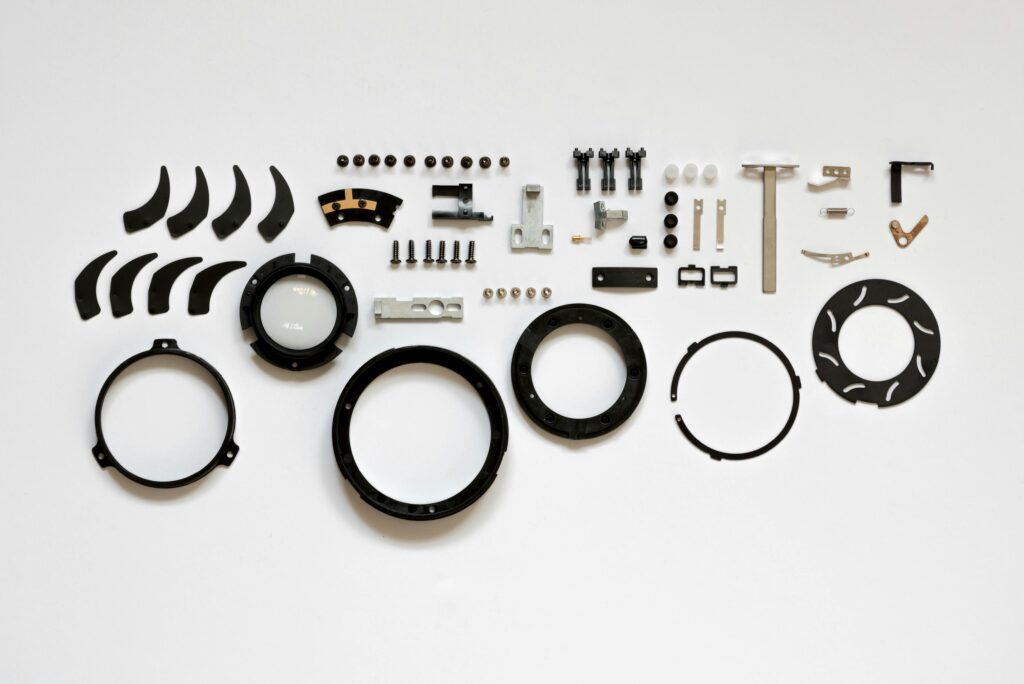 Organized layout of mechanical parts on a white surface, ideal for tech and engineering themes.
